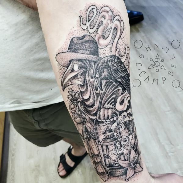 Black and grey plague doctor with raven and flowers tattoo. Book a custom tattoo with John at Sacred Mandala Studio - Durham, NC.